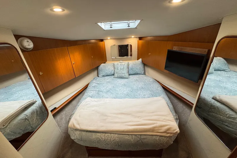 Slide: The Image of Luxurious cabin interior of 1998 Ocean Yachts 48 Super Sport with cozy bedding. - 21