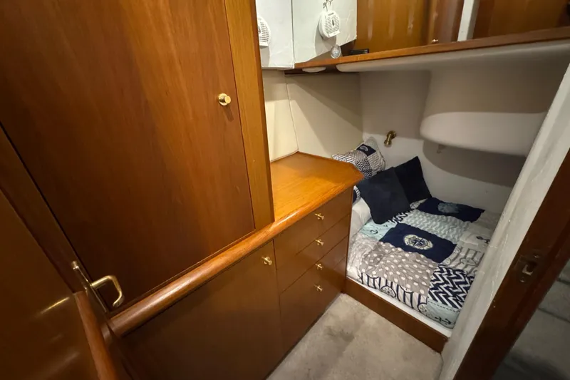 Slide: The Image of Cozy cabin interior of 1998 Ocean Yachts 48 Super Sport with wooden cabinetry and bedding. - 25