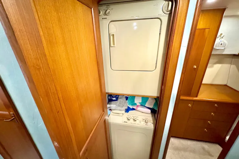 Slide: The Image of Laundry area with stacked washer and dryer in 1998 Ocean Yachts 48 Super Sport. - 26