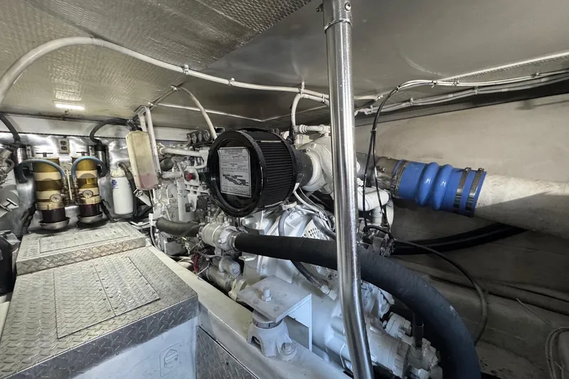Slide: The Image of Engine room of 1998 Ocean Yachts 48 Super Sport, showcasing mechanical components and piping. - 37