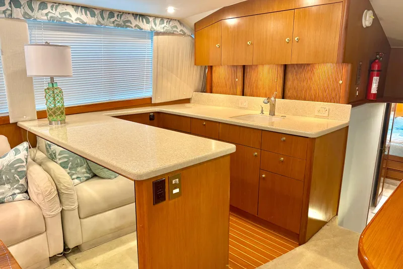 Slide: The Image of Luxurious interior of 1998 Ocean Yachts 48 Super Sport with modern kitchen and cozy seating. - 7