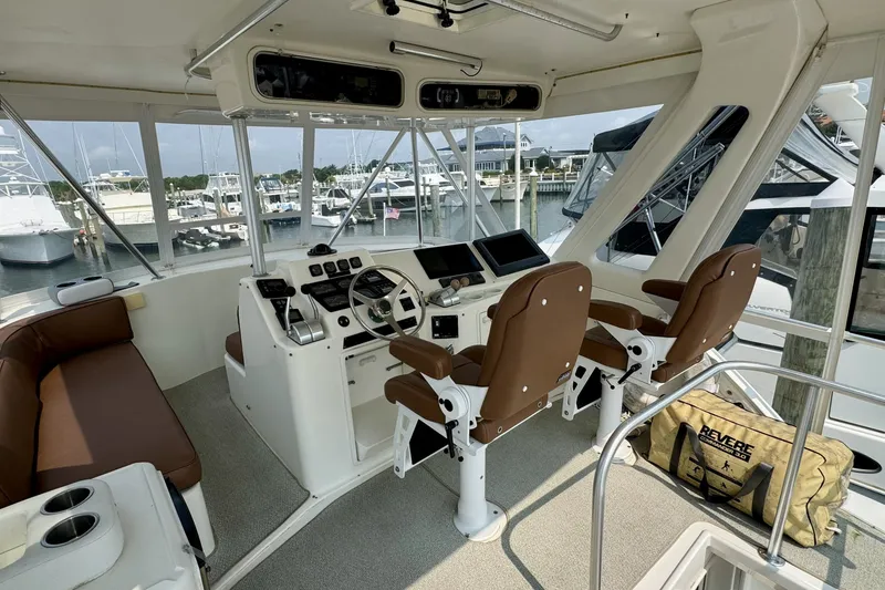 Slide: The Image of Interior view of 1998 Ocean Yachts 48 Super Sport helm with brown seating and navigation equipment. - 27