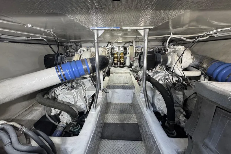 Slide: The Image of Engine room of a 1998 Ocean Yachts 48 Super Sport, showcasing dual engines and mechanical components. - 36