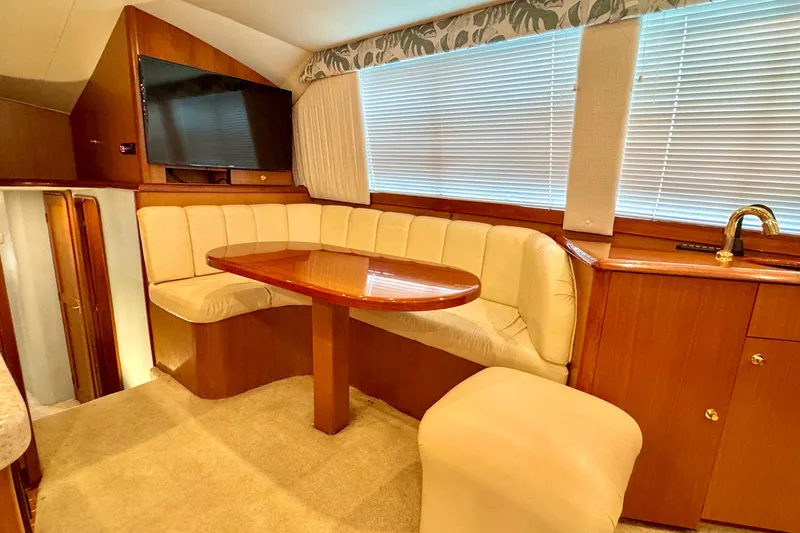 Slide: The Image of Luxurious interior of 1998 Ocean Yachts 48 Super Sport with plush seating and elegant wood finishes. - 8