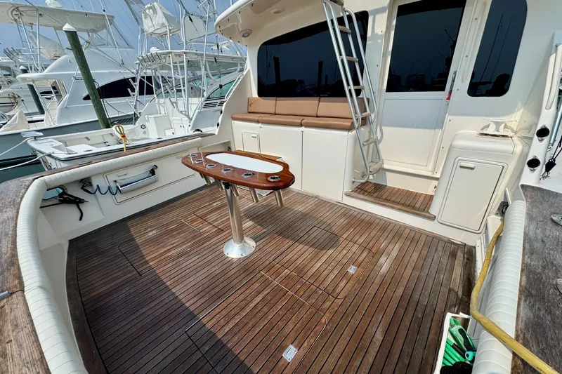 Slide: The Image of 1998 Ocean Yachts 48 Super Sport yacht deck with seating and fishing rod holders. - 33