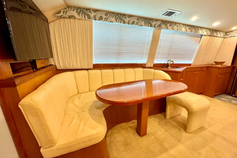 Slide: The Image of Luxurious interior of a 1998 Ocean Yachts 48 Super Sport with plush seating and elegant wood finishes. - 9