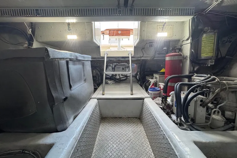 Slide: The Image of Engine room of a 1998 Ocean Yachts 48 Super Sport, featuring equipment and access ladder. - 39