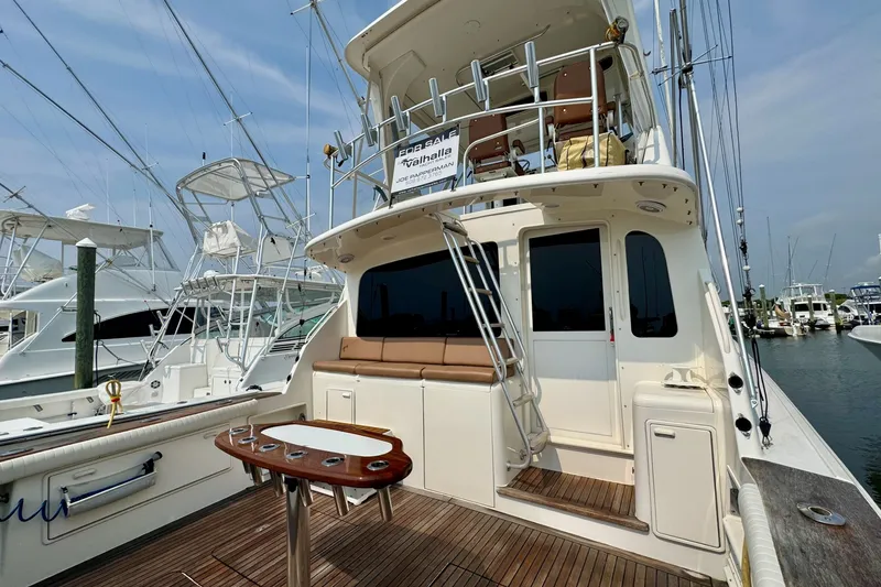 Slide: The Image of 1998 Ocean Yachts 48 Super Sport docked, featuring spacious deck and seating area. - 32