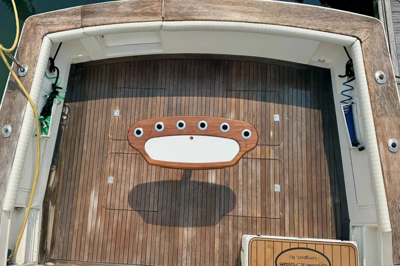 Slide: The Image of Cockpit view of 1998 Ocean Yachts 48 Super Sport with teak flooring and fishing rod holders. - 35