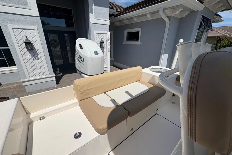 Slide: The Image of 2022 Sea Born LX22 Center Console boat parked in front of a modern house. - 14