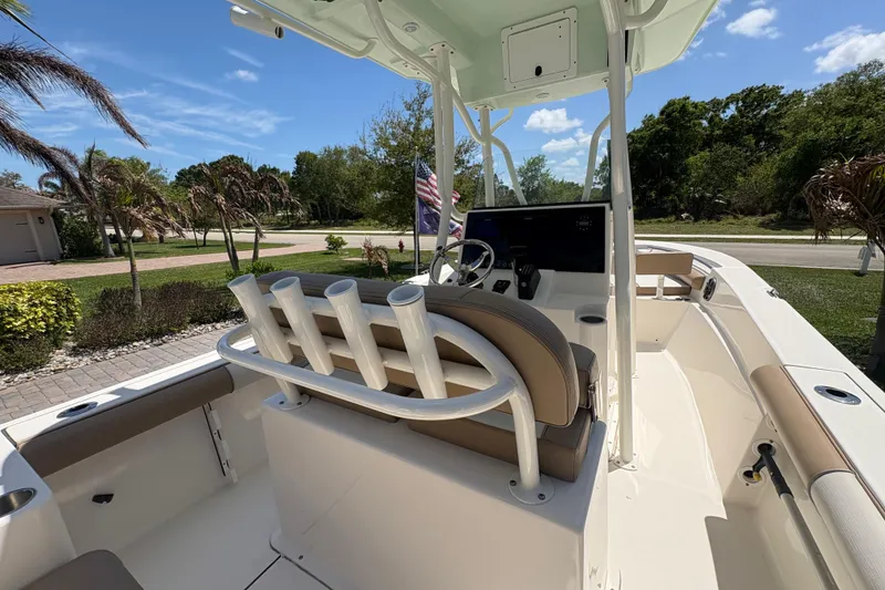 Slide: The Image of 2022 Sea Born LX22 Center Console boat interior with beige seating and control panel. - 15