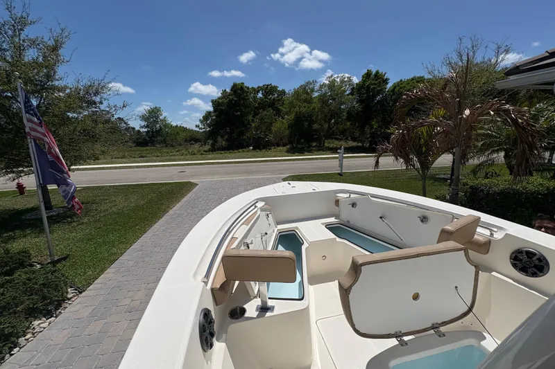 Slide: The Image of 2022 Sea Born LX22 Center Console boat interior with steering wheel and controls. - 16