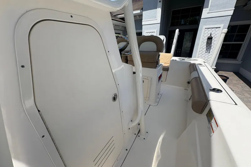 Slide: The Image of 2022 Sea Born LX22 Center Console boat interior with beige seating and control panel. - 26