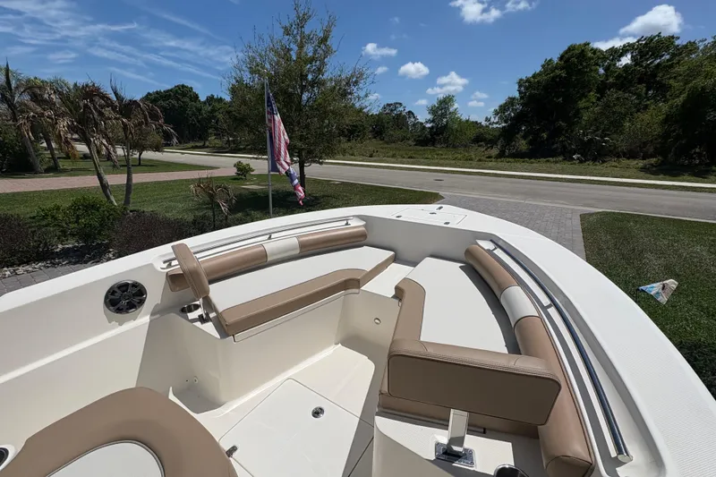 Slide: The Image of 2022 Sea Born LX22 Center Console boat on trailer in driveway, sunny day. - 4