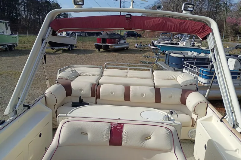 Slide: The Image of Interior of a 2000 Crest 25 Ultra pontoon boat with beige and maroon seating. - 5
