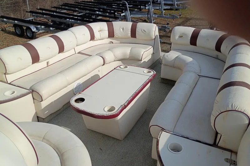 Slide: The Image of Luxurious seating on a 2000 Crest 25 Ultra pontoon boat with beige and brown upholstery. - 6