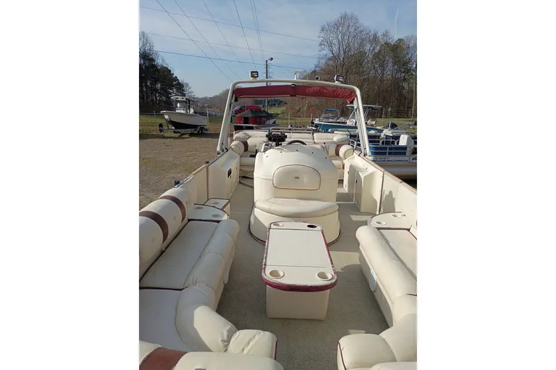 Slide: The Image of Interior view of a 2000 Crest 25 Ultra pontoon boat with beige seating. - 7