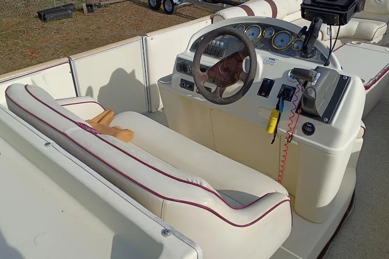 Slide: The Image of Interior of a 2000 Crest 25 Ultra boat with steering wheel and control panel. - 8