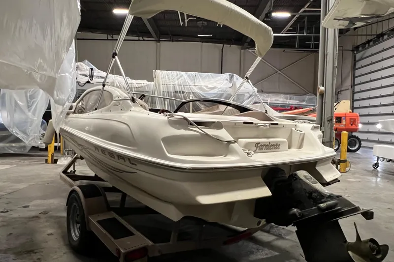 Slide: The Image of 2001 Regal 1900 LSR boat in storage, rear view with trailer. - 12