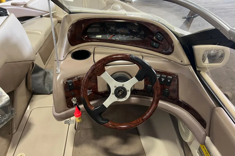 Slide: The Image of 2001 Regal 1900 LSR boat dashboard with wood-trimmed steering wheel and instrument panel. - 3