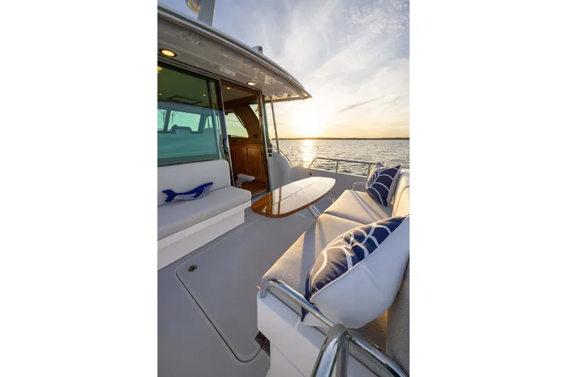 Slide: The Image of Luxurious 2027 Sabre 38 Salon Express yacht interior with sunset view over the water. - 3