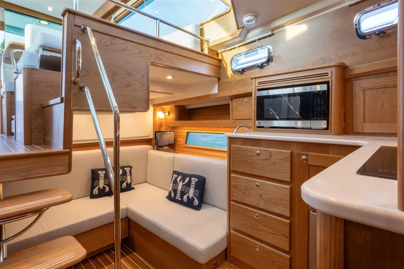 Slide: The Image of Luxurious interior of 2027 Sabre 38 Salon Express yacht with modern kitchen and seating area. - 10