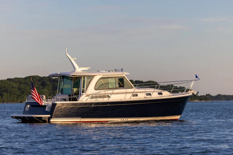 The Image of 2027 Sabre 38 Salon Express yacht cruising on calm waters at sunset. - 0