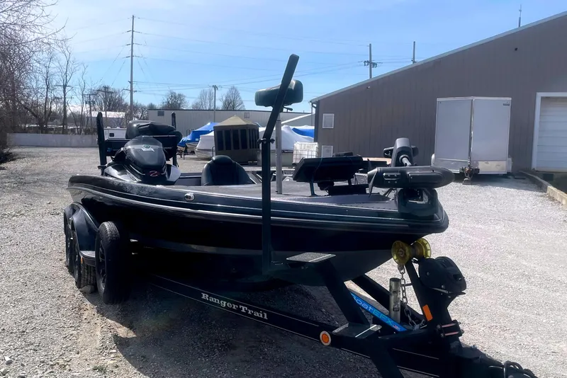 Slide: The Image of 2017 Ranger Z520 boat on trailer in outdoor setting near water. - 2