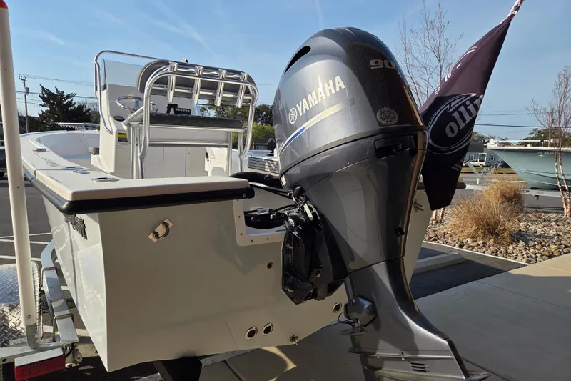 Slide: The Image of 2026 May-Craft 182 Center Console boat with Yamaha 90 engine, parked outdoors. - 3