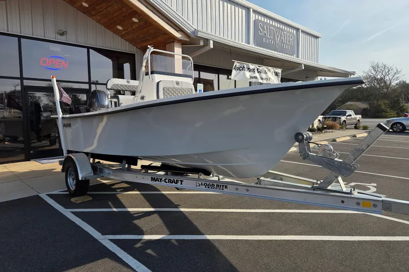 Slide: The Image of 2026 May-Craft 182 Center Console boat on trailer outside Saltwater Outfitters store. - 4