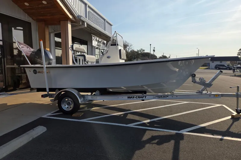 Slide: The Image of 2026 May-Craft 182 Center Console boat on trailer, parked outside a building. - 5