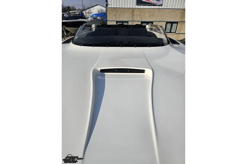 Slide: The Image of 2009 Nordic 36 Hurricane boat with sleek white exterior and windshield, parked outdoors. - 102