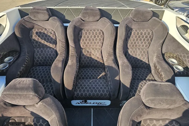 Slide: The Image of Luxurious seating in a 2009 Nordic 36 Hurricane boat, featuring plush, patterned upholstery. - 104