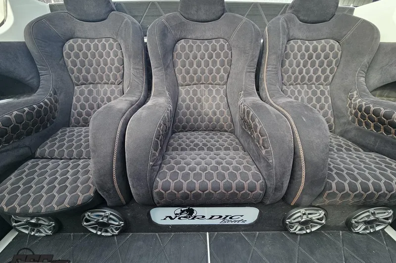 Slide: The Image of Luxurious seating in a 2009 Nordic 36 Hurricane boat with hexagonal pattern upholstery. - 105