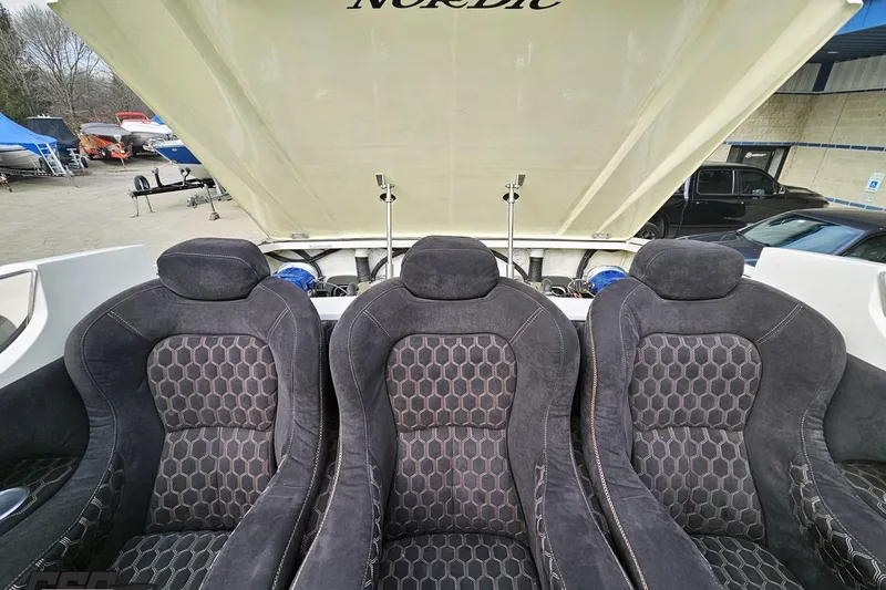 Slide: The Image of Three black seats in a 2009 Nordic 36 Hurricane boat interior. - 109