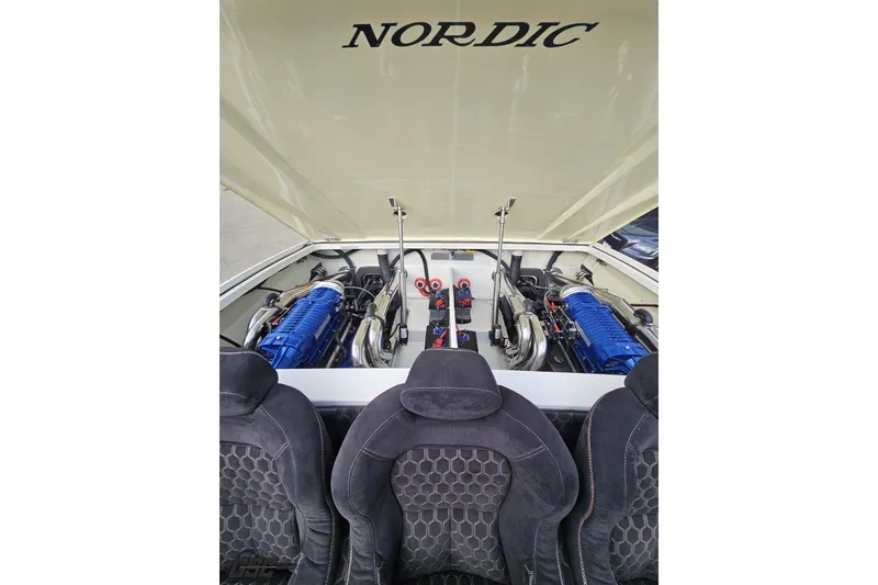 Slide: The Image of Engine compartment of a 2009 Nordic 36 Hurricane boat with dual blue engines. - 111