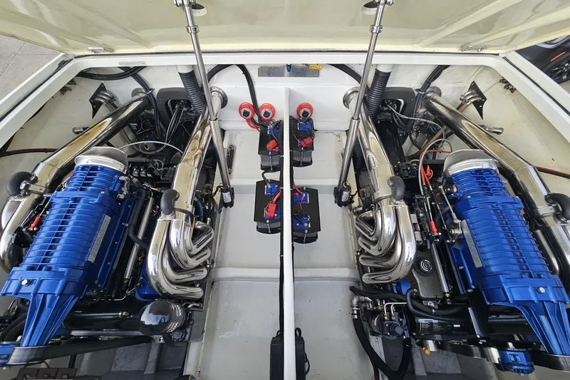 Slide: The Image of Engine compartment of a 2009 Nordic 36 Hurricane boat with dual blue engines. - 114