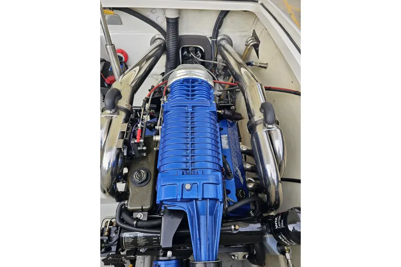 Slide: The Image of Engine of 2009 Nordic 36 Hurricane boat with blue components and chrome exhaust. - 115