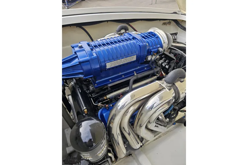 Slide: The Image of Engine of 2009 Nordic 36 Hurricane boat with blue supercharger and chrome exhaust. - 116