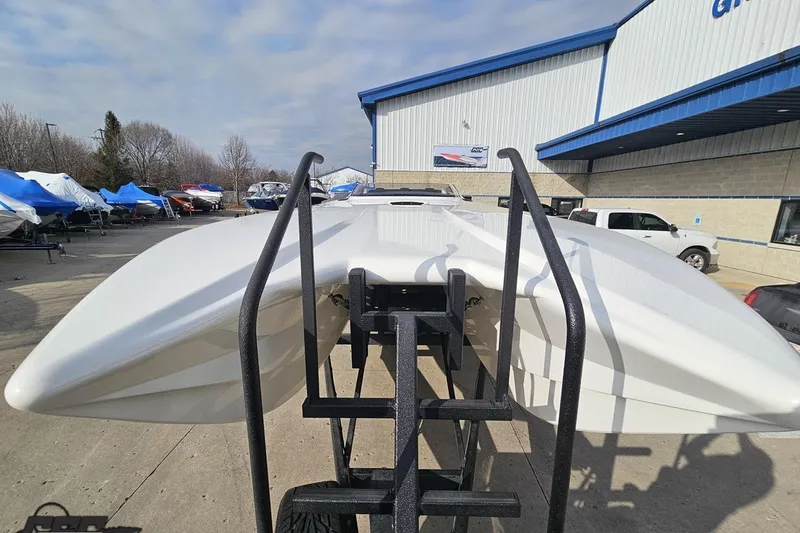 Slide: The Image of 2009 Nordic 36 Hurricane boat on trailer outside dealership, under cloudy sky. - 12