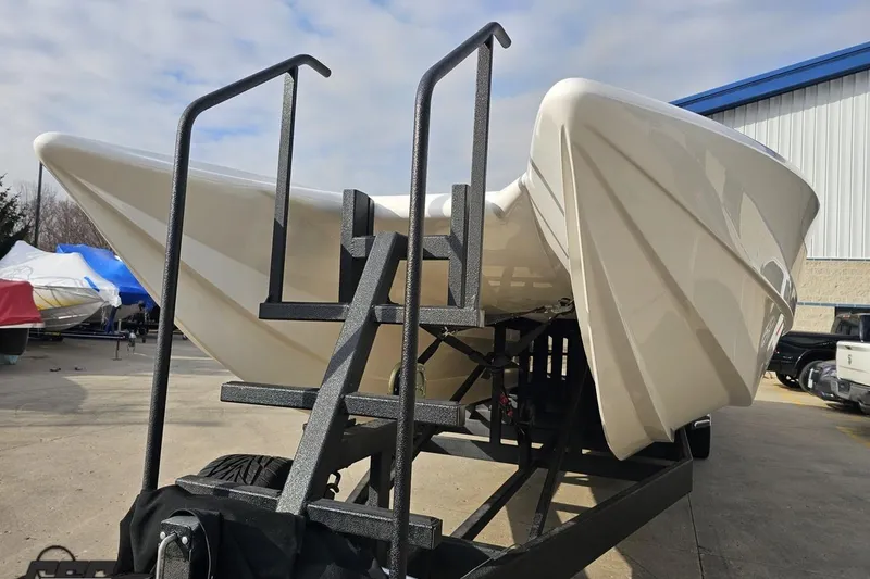 Slide: The Image of 2009 Nordic 36 Hurricane boat on trailer, viewed from the front in a storage area. - 16