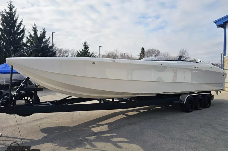 Slide: The Image of 2009 Nordic 36 Hurricane boat on trailer, parked outdoors under cloudy sky. - 17