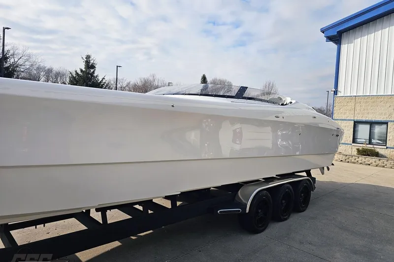 Slide: The Image of 2009 Nordic 36 Hurricane boat on trailer, parked outside a building. - 18