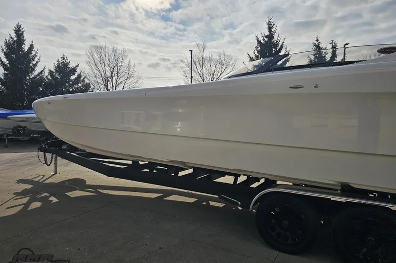 Slide: The Image of 2009 Nordic 36 Hurricane boat on trailer under cloudy sky. - 20