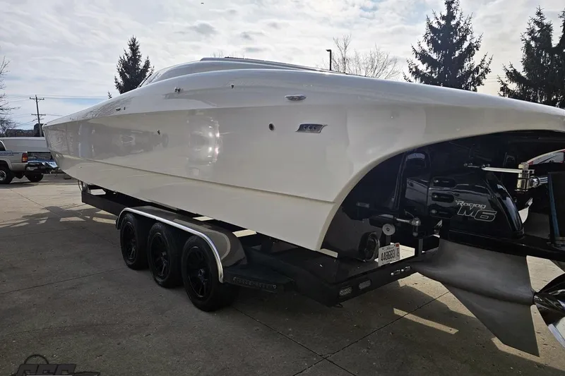 Slide: The Image of 2009 Nordic 36 Hurricane boat on trailer, side view with trees in background. - 22