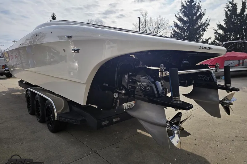 Slide: The Image of 2009 Nordic 36 Hurricane boat on trailer, showcasing dual propellers. - 23