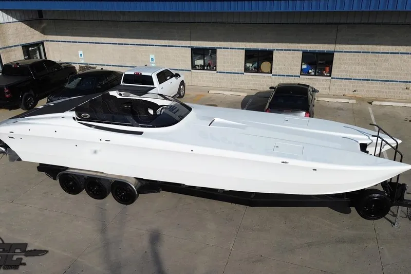 Slide: The Image of 2009 Nordic 36 Hurricane boat on trailer in parking lot. - 32