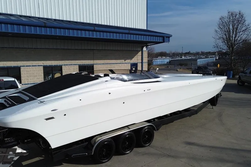 Slide: The Image of 2009 Nordic 36 Hurricane speedboat on trailer outside industrial building. - 33