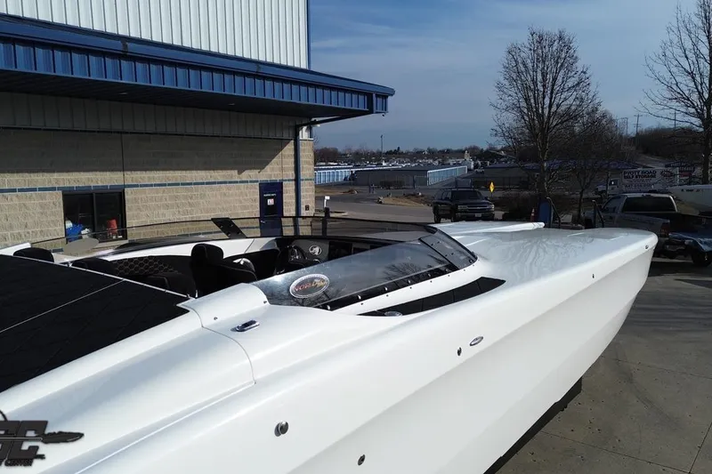 Slide: The Image of 2009 Nordic 36 Hurricane boat parked outside a building on a sunny day. - 34