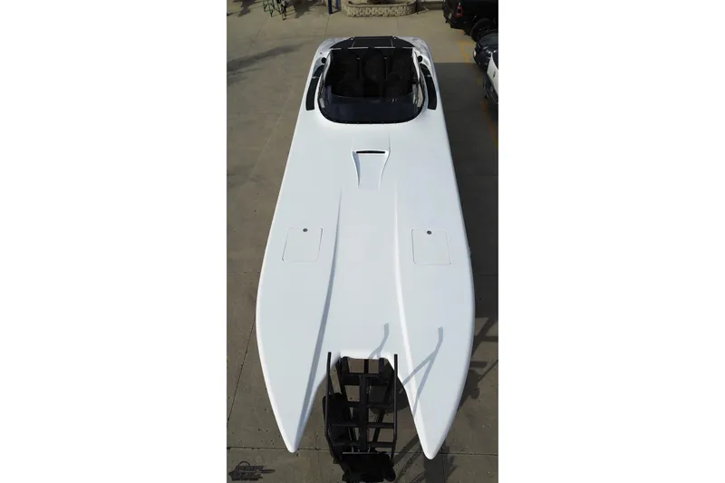 Slide: The Image of 2009 Nordic 36 Hurricane boat, aerial view, sleek white design, parked on concrete surface. - 37